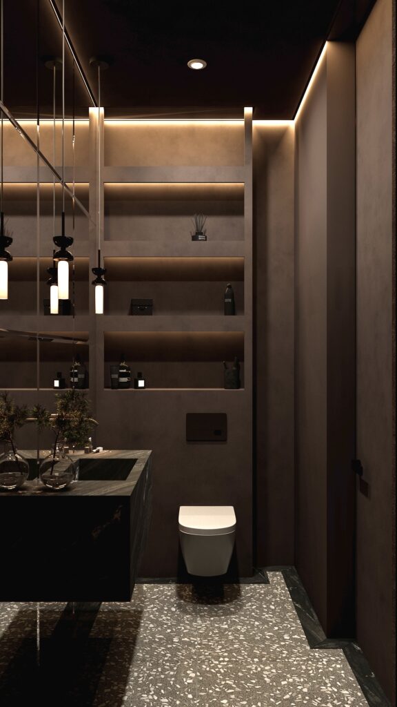 Baie modernă neagră cu lavoar masiv din marmură neagră, pardoseală tip terrazzo gri, perete cu aspect cortén și pendule minimaliste de sticlă, cu tavan negru și scafe LED. Amenajare realizată de Fabiano Interiors, expert design interior Oradea.