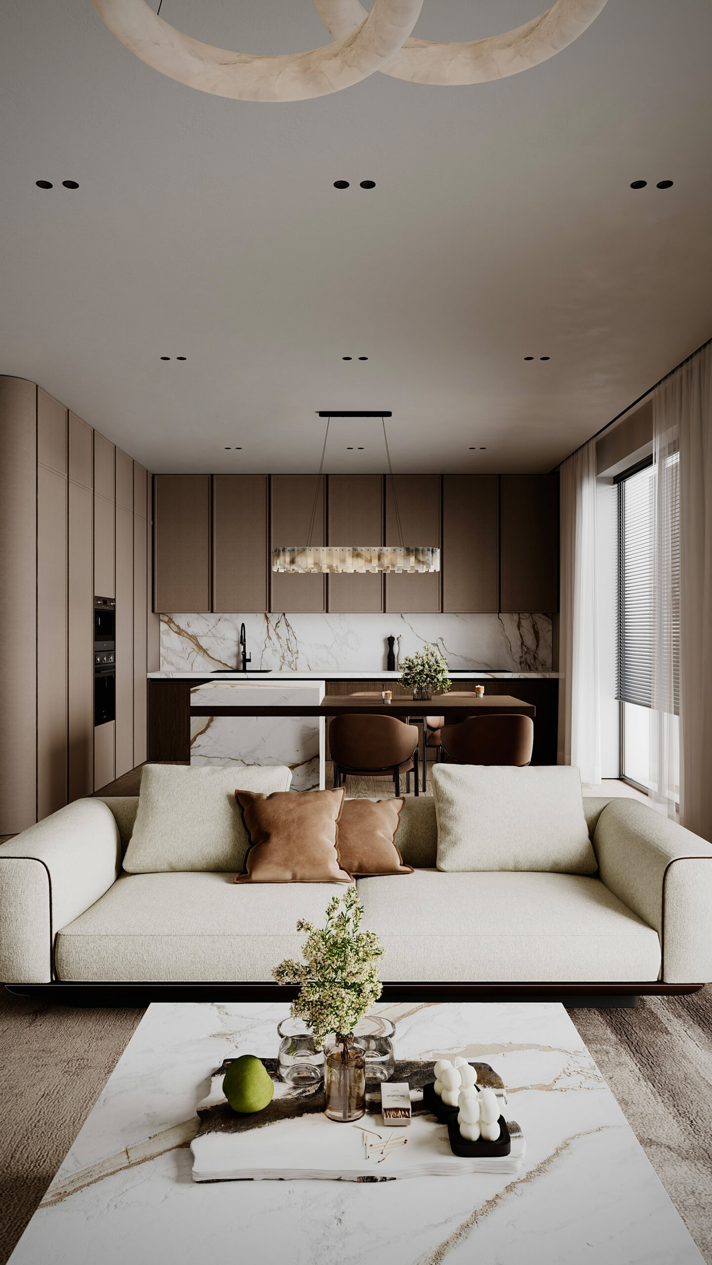 Amenajare open space cu bucătărie și living, insulă din marmură, mobilier minimalist în tonuri de bej și corpuri de iluminat circulare, design Fabiano Interiors.