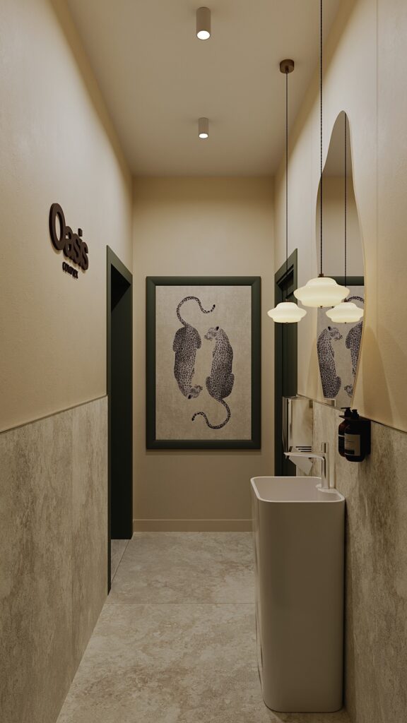 Amenajare spațiu sanitar comercial realizată de Fabiano Interiors, un proiect de design interior în Oradea caracterizat prin nuanțe calde de bej, uși elegante verde închis, oglindă decorativă fluidă, corpuri de iluminat elegante suspendate și placări ceramice stil travertin pentru un ambient relaxant.