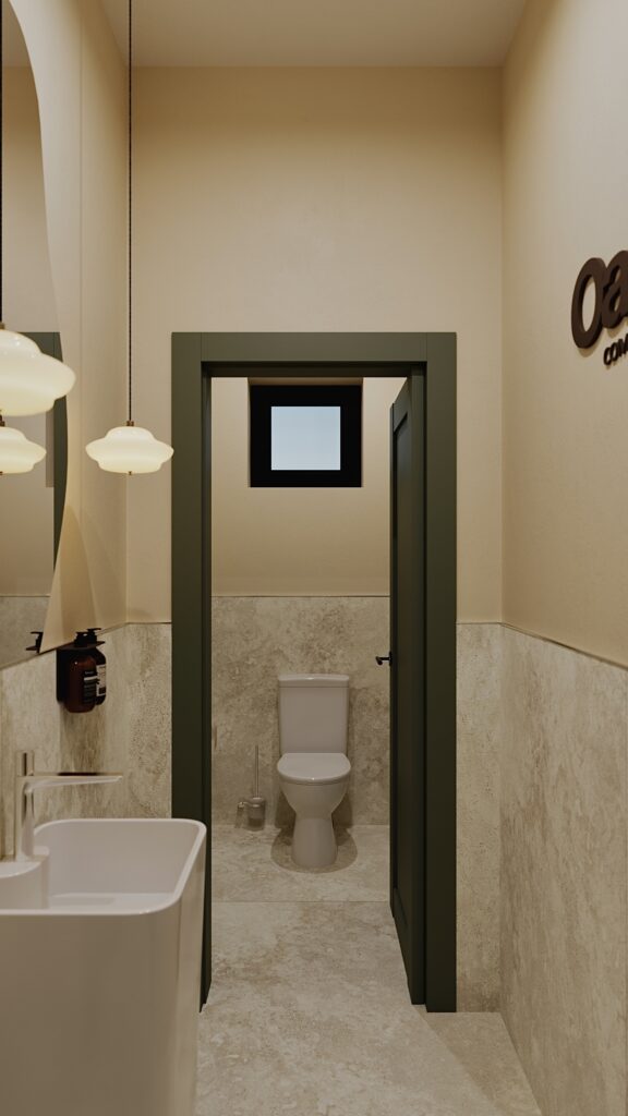 Design interior baie și hol de acces realizat de Fabiano Interiors în Oradea pentru Oasis Complex, cu lavoar freestanding freestanding modern, oglindă asimetrică organică, corpuri de iluminat suspendate cu design retro-minimalist, uși verzi în nuanță măslinie, placări ceramice cu aspect de piatră naturală și tablou decorativ.